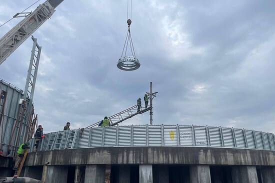 Grain silo roof installation, crane operations at the elevator construction site